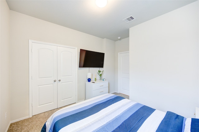 bedroom with a closet and light colored carpet