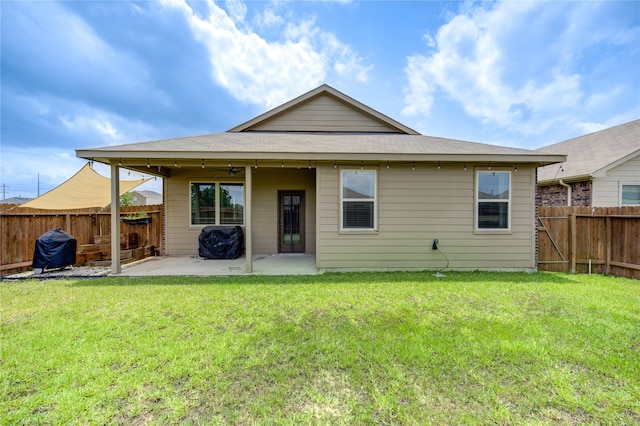 back of house with a yard, a patio, and ceiling fan