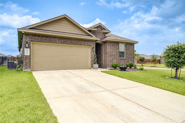 view of front of house with a front lawn, central AC unit, and a garage