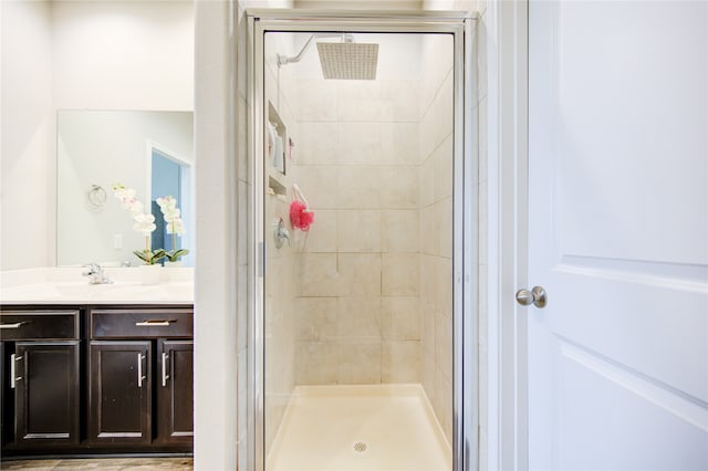 bathroom featuring vanity and an enclosed shower