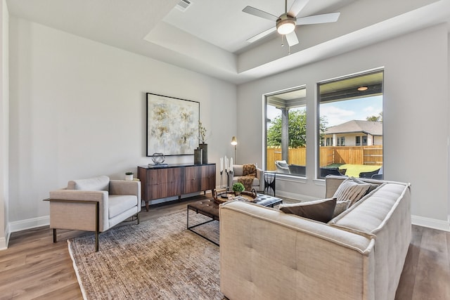 living room featuring hardwood / wood-style floors and ceiling fan