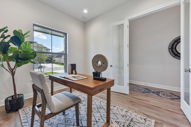 office with french doors and light wood-type flooring