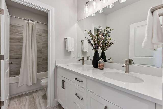 full bathroom featuring shower / tub combo, vanity, and toilet