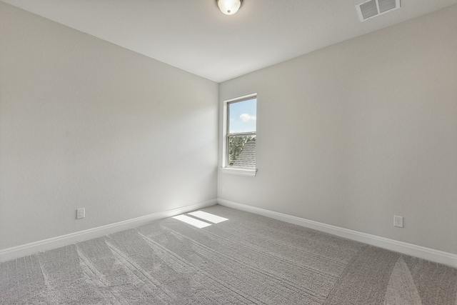 carpeted spare room with vaulted ceiling