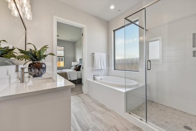 bathroom featuring sink, shower with separate bathtub, and a wealth of natural light