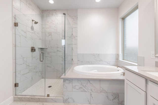 bathroom featuring vanity and plus walk in shower