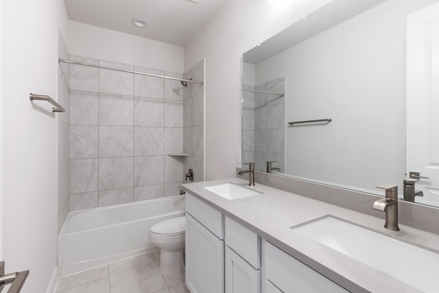 full bathroom featuring toilet, vanity, tile patterned floors, and tiled shower / bath