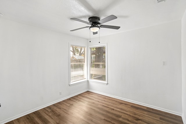 unfurnished room with dark hardwood / wood-style flooring and ceiling fan