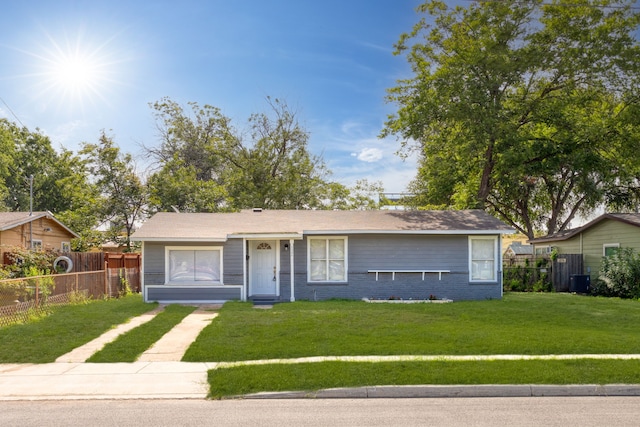 ranch-style home featuring a front yard