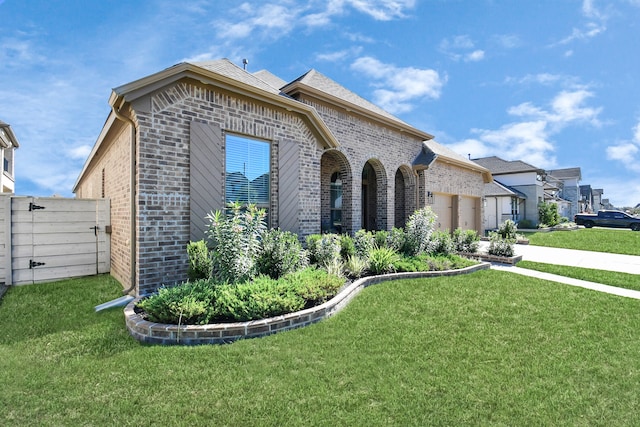 view of front facade with a garage and a front lawn