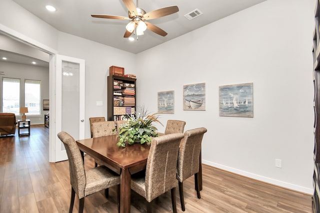 dining room with hardwood / wood-style floors and ceiling fan