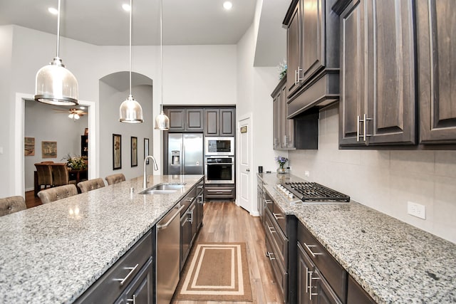 kitchen featuring dark brown cabinets, sink, dark wood-type flooring, and appliances with stainless steel finishes