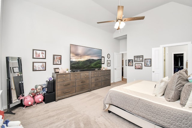 carpeted bedroom with ceiling fan and high vaulted ceiling