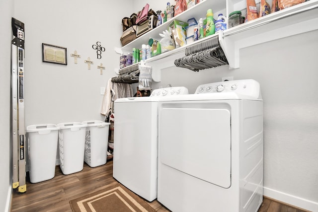 laundry area with washing machine and clothes dryer and dark hardwood / wood-style flooring