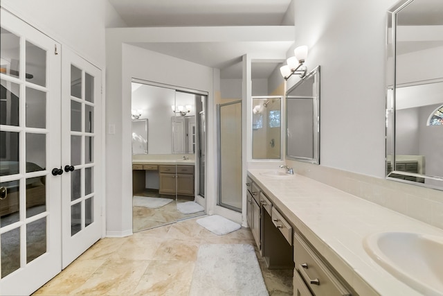 bathroom featuring french doors, vanity, and a shower with door