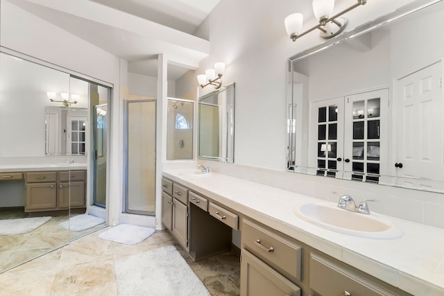 bathroom with vanity and a shower with door