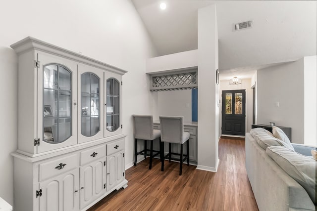 interior space with high vaulted ceiling and dark hardwood / wood-style floors