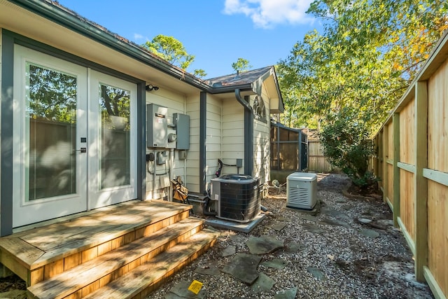 exterior space with cooling unit and french doors