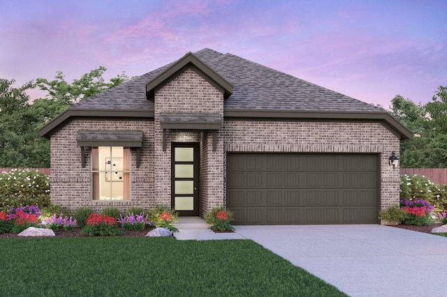 view of front facade featuring driveway, an attached garage, a yard, a shingled roof, and brick siding