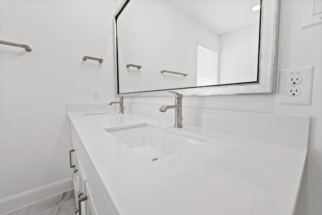 bathroom with vanity and baseboards