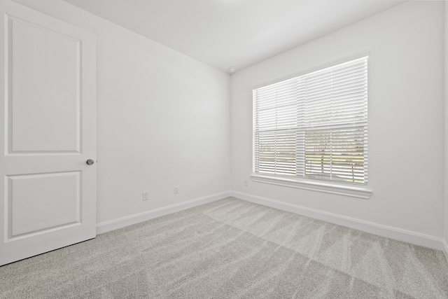 carpeted spare room with baseboards