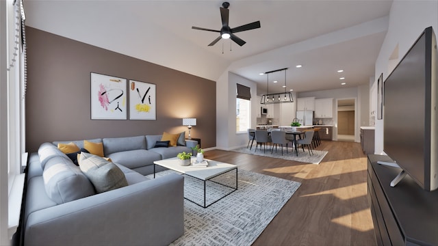 living area with recessed lighting, a ceiling fan, baseboards, and light wood-type flooring