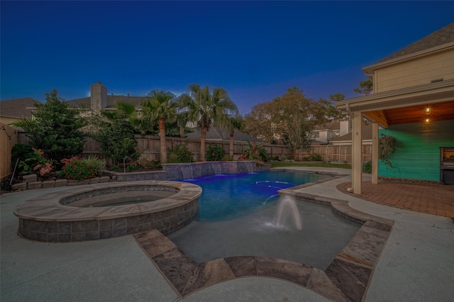 view of swimming pool with an in ground hot tub and pool water feature