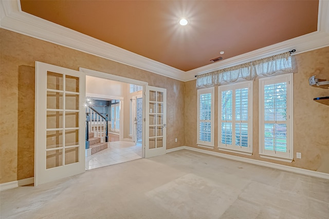 unfurnished room with carpet flooring, ornamental molding, and french doors