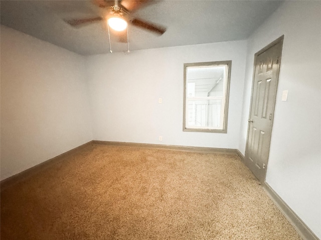 empty room featuring carpet flooring and ceiling fan