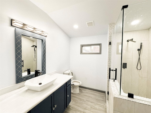 bathroom with lofted ceiling, toilet, walk in shower, and vanity