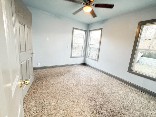 spare room featuring ceiling fan and carpet floors