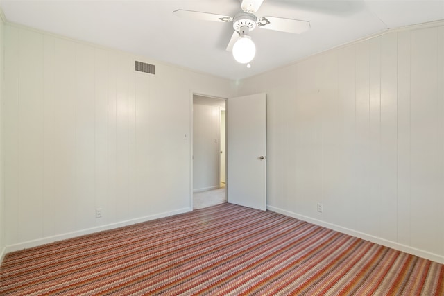 spare room featuring carpet floors and ceiling fan