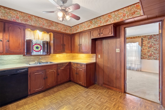 kitchen featuring ceiling fan, sink, black dishwasher, light parquet floors, and wooden walls