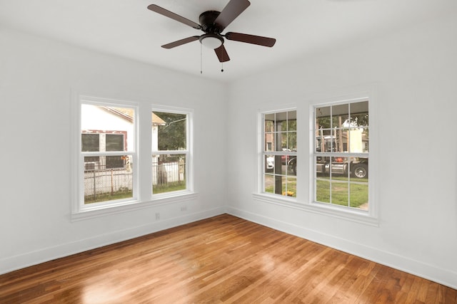 empty room featuring ceiling fan and hardwood / wood-style floors