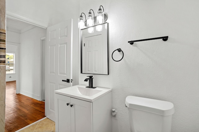 bathroom with tile patterned flooring, vanity, and toilet