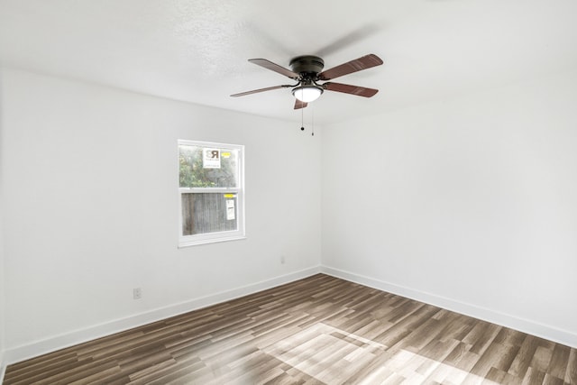 empty room featuring ceiling fan and hardwood / wood-style flooring