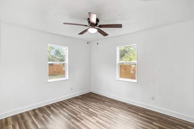 spare room featuring hardwood / wood-style flooring, ceiling fan, a textured ceiling, and a wealth of natural light