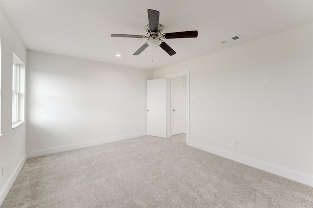 spare room featuring recessed lighting, visible vents, light carpet, ceiling fan, and baseboards