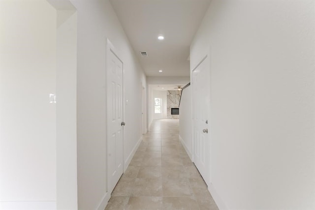 corridor featuring light tile patterned floors