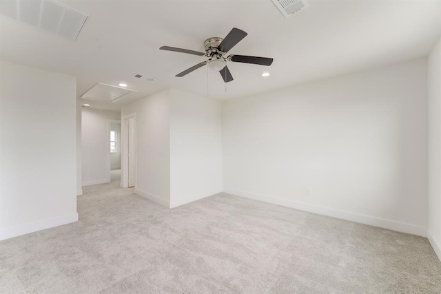 spare room featuring recessed lighting, light carpet, a ceiling fan, visible vents, and baseboards