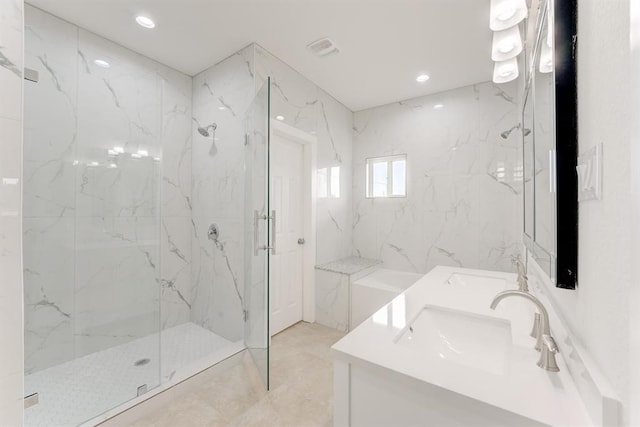 full bath with double vanity, a marble finish shower, a sink, and recessed lighting