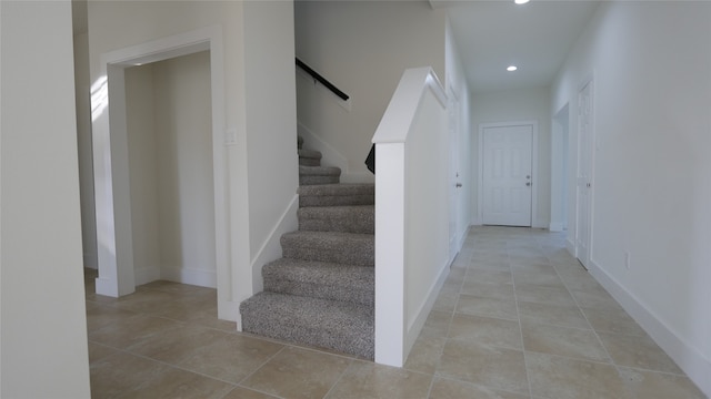 stairs with tile patterned flooring, baseboards, and recessed lighting