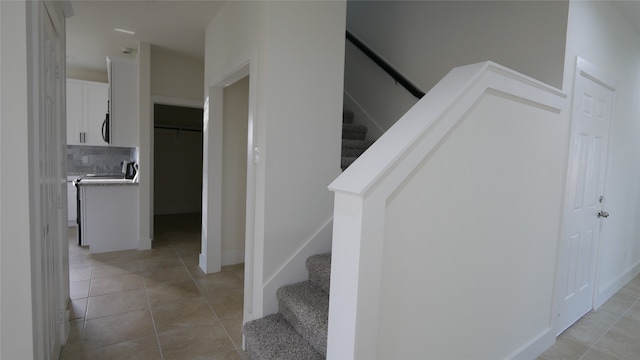 stairway featuring tile patterned flooring