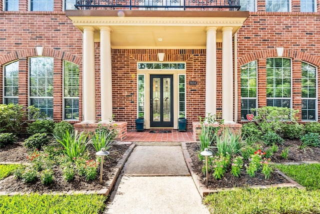 property entrance with french doors and brick siding