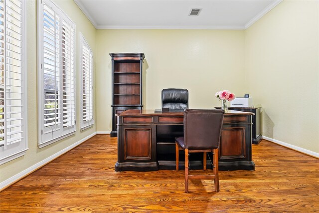 home office with hardwood / wood-style floors and crown molding