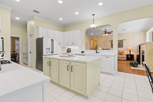 kitchen with ceiling fan, sink, crown molding, pendant lighting, and high quality fridge