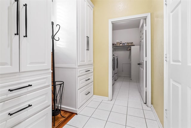 walk in closet featuring light tile patterned floors and washer and clothes dryer