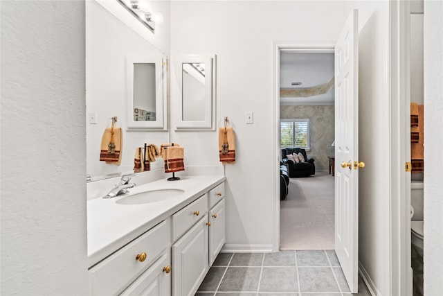 bathroom featuring tile patterned floors, vanity, and toilet