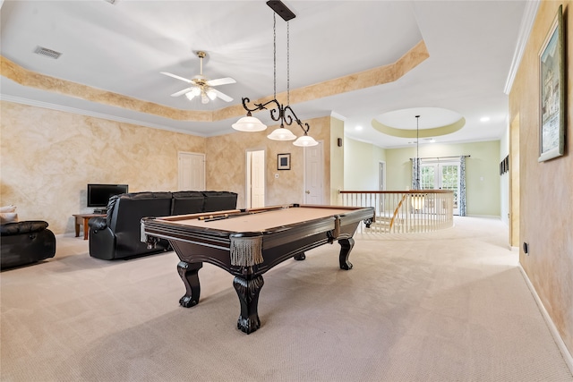 recreation room with ceiling fan, crown molding, light colored carpet, a tray ceiling, and pool table