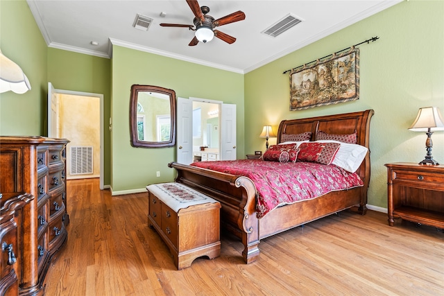 bedroom with hardwood / wood-style floors, ensuite bathroom, ceiling fan, and crown molding